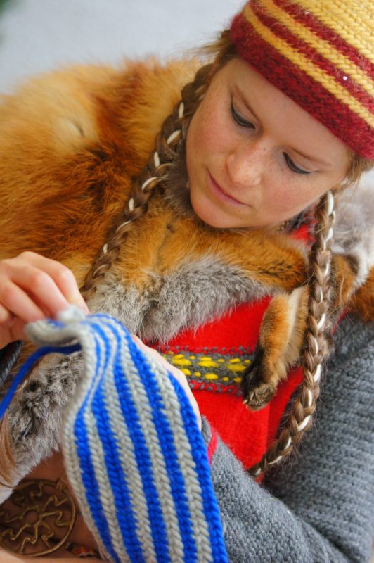 Scandinavian woman doing nalbinding, a fabric making technique that pre-dates knitting